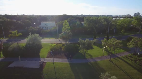 Aerial View Running Woman with Middle Aged Fitness Trainer in Park on Asphalt Track