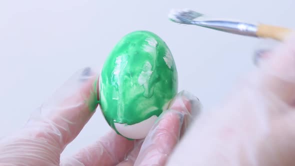 Closeup of a Person Painting Easter Eggs with a Special Brush