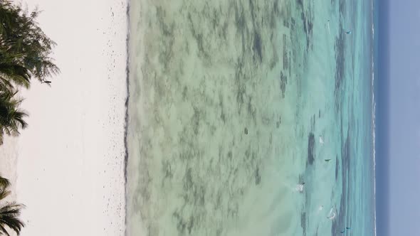 Vertical Video Kitesurfing Near the Shore of Zanzibar Tanzania Aerial View