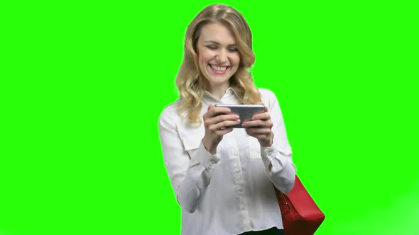 Excited Woman Using Smartphone on Green Screen Background