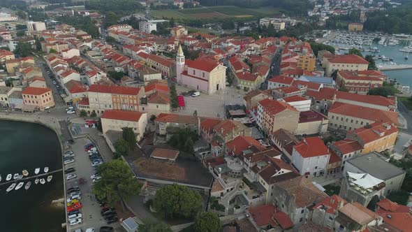 Aerial view of Porec, Parenzo main square and church at evening