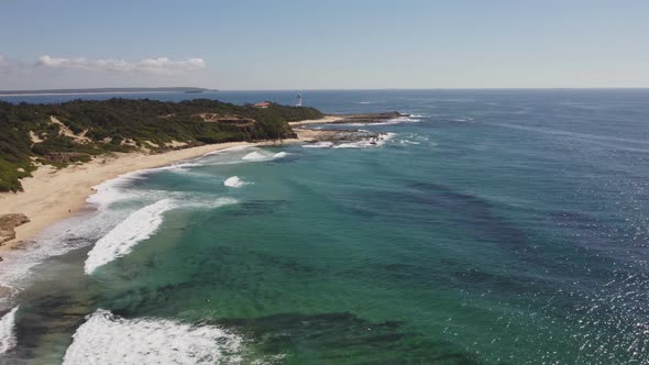 aerial descending clip of pebbly beach at norah head