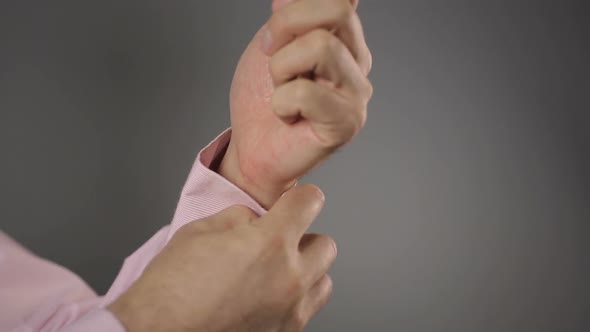 Businessman Fastening Button on His Shirt Sleeve and Showing Thumbs Up