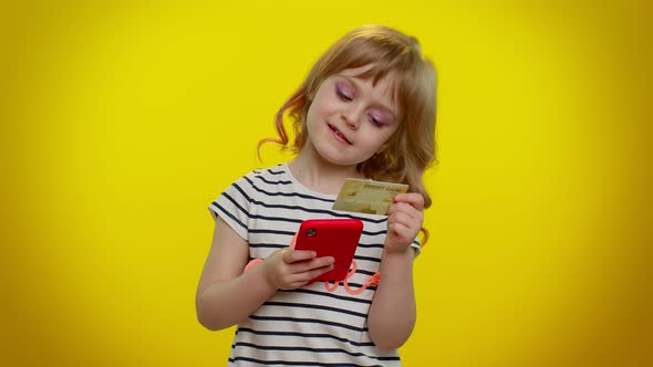 Little Teen Kid Child Girl Using Credit Bank Card and Smartphone While Purchases Online Shopping