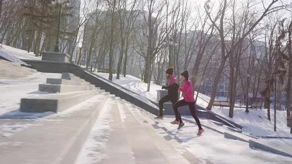 Slow Motion People Jogging on Staircase in Winter