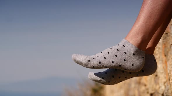 Female Feet in Socks Dangling