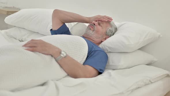 Headache Tense Old Man With Head Pain Lying in Bed