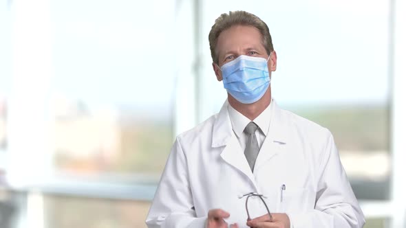 Physician in Protective Mask Put on Stethoscope