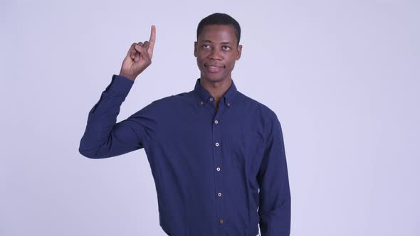 Young Happy African Businessman Pointing Up