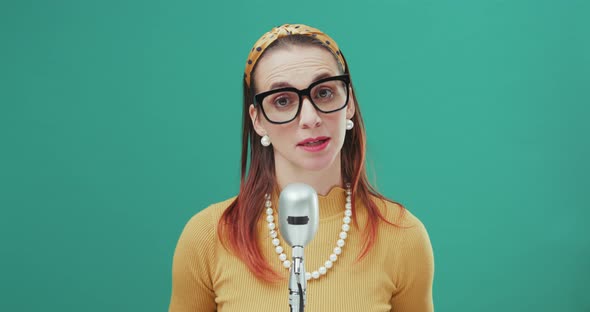 Woman speaking into a microphone.