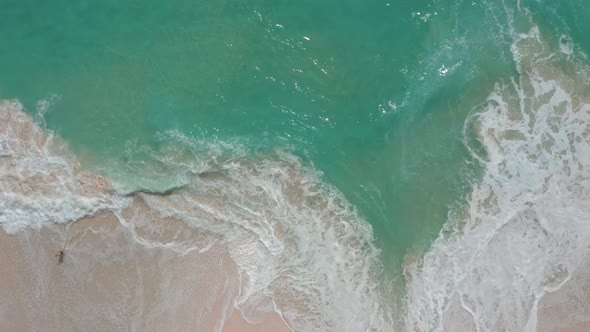 Aerial View of Blue Ocean Waves Crashing at White Sand Beach