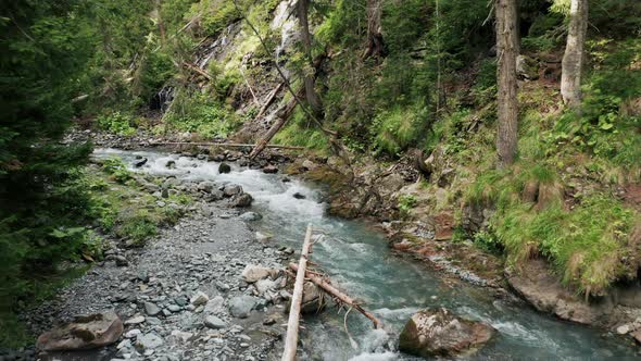 Aerial view; young man walking on suspension bridge