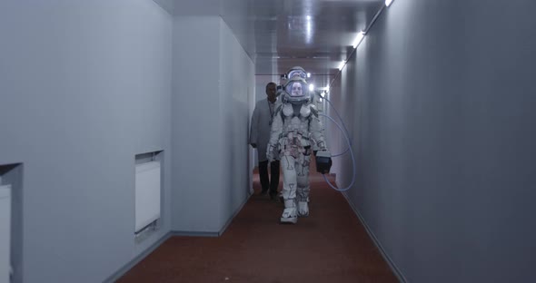 Astronauts Walking Down a Corridor