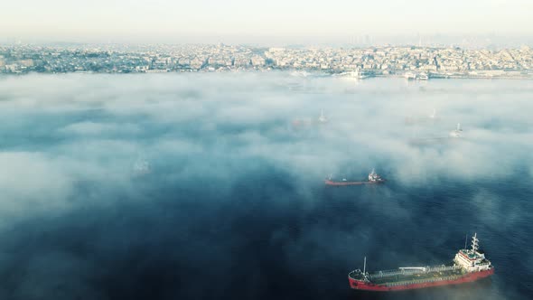drone flying above sea with city view in foggy day