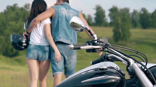 Backside View Man in Denim Dressing Hugs Young Woman