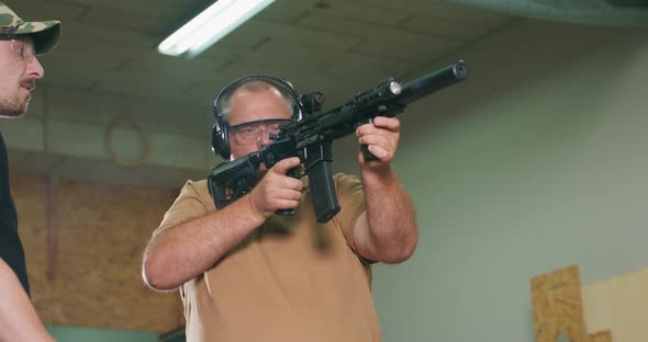 The Stressed Student Fires the First Shot From the Rifle at the Shooting Range