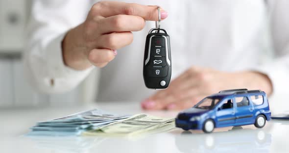 Car Dealer Hands Over Car Alarm Key Closeup