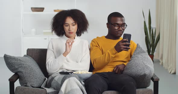 Couple of Teenagers Afro American Young Newlyweds Husband and Wife Sitting at Home on Couch