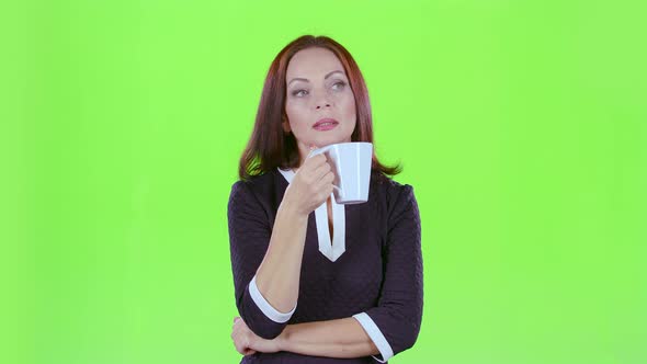 Woman with a Mug of Tea Looks Into the Distance and Thinks About Her Own Affairs, Green Screen