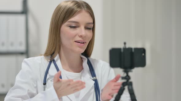 Portrait of Female Doctor Recording Video on Smartphone