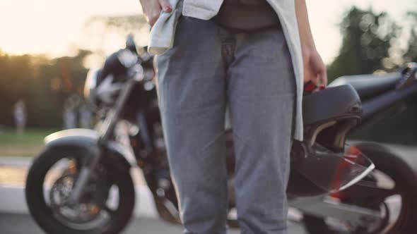 Beautiful Young Redhaired Woman Motorcyclist with Her Motorcycle and Helmet