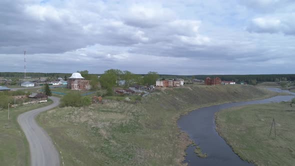 Aerial view of old village with ruined buildings on bank of the river 01