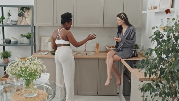 Happy Lesbian Couple Having Fun in Kitchen in Morning