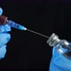Doctor's Hand Holds Syringe Red Vaccine Bottle Hospital Black Background - VideoHive Item for Sale