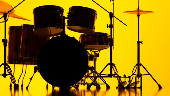 Details of drum kit on a bright yellow background. Percussion chrome hardware.