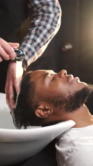 Young Africanamerican Man Visiting Barbershop