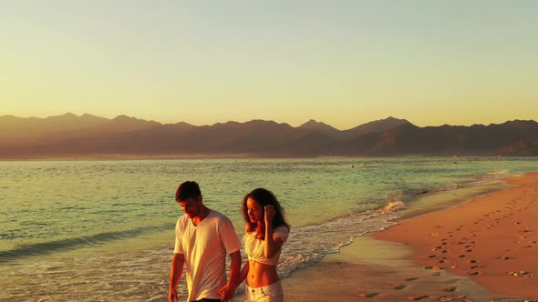 Romantic Lady and Man in Love Dating on Vacation Enjoy Luxury on Beach on Paradise White Sand Backgr