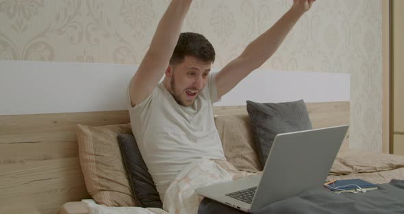 the Boy Looks at the Computer and is Happy