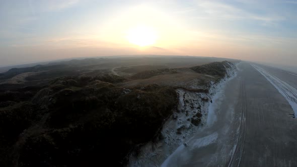 Aerial shot in the winter. Sunset by the sea.