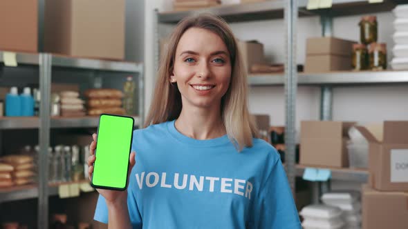 Female Volunteer Holding Smartphone with Chroma Key Screen