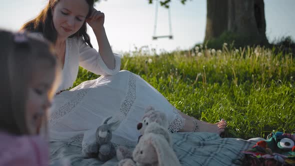 A Young Mother and Her Two Little Daughters Made a Picnic in a Clearing Near a Lonely Old Oak