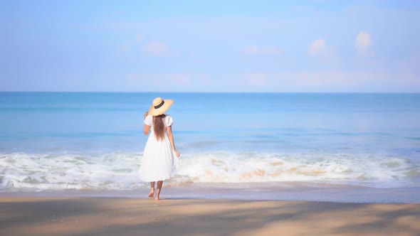 Asian woman enjoy around beautiful beach sea ocean