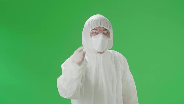 Angry Man Wear Protective Uniform PPE And Pointing To The Camera In The Green Screen Studio