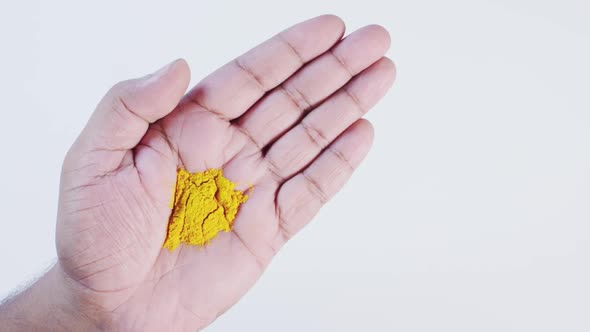 Turmeric Powder In Hand 2