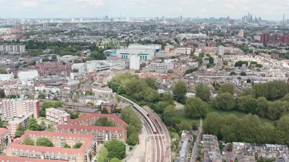 Drone shot over district line underground trains towards Stamford Bridge chelsea stadium London