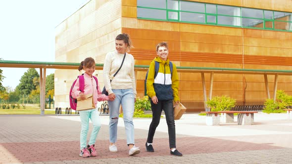 Mother with Son and Daughter Going To School