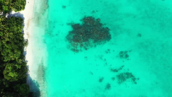 Aerial flying over scenery of perfect lagoon beach trip by blue green ocean and white sandy backgrou