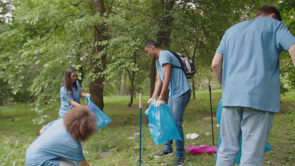 Group of Diverse Ecofriendly Volunteers Caring for Nature and Ecology