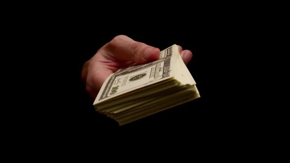 Male hands holding many banknotes isolated on black background