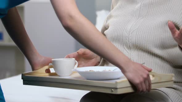 Naughty Elderly Female Refusing to Eat Porridge in Nursing Home, Untasty Food