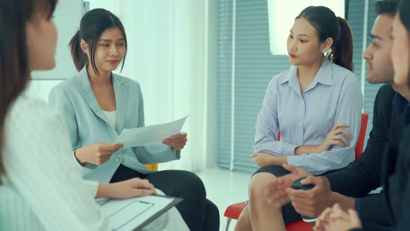 Business People Proficiently Discuss Work Project While Sitting in Circle