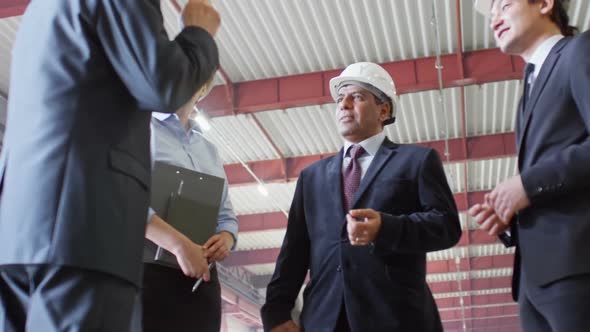 Team of Engineers Having Business Meeting at Factory