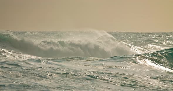 Ocean Waves Rolling on Beach of Nazare Coast at Sunset Portugal