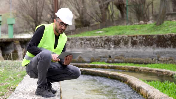 Engineer Investigates in Electric Water Dam