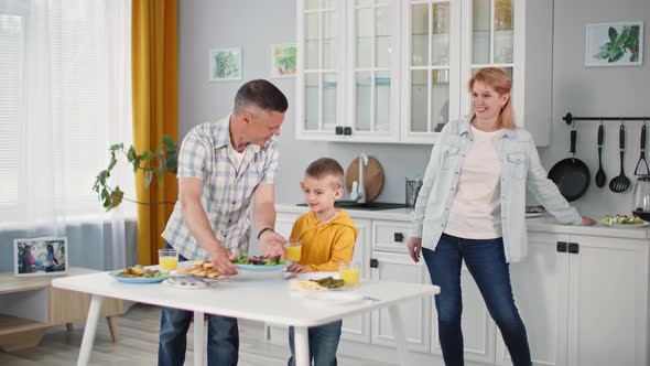 Family Lunch Joyful Caring Parents Together with Their Young Son Set Table for Joint Dinner in