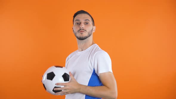 Happy Confident Football Player in White Blue Shirt Throwing in Air Soccer Ball